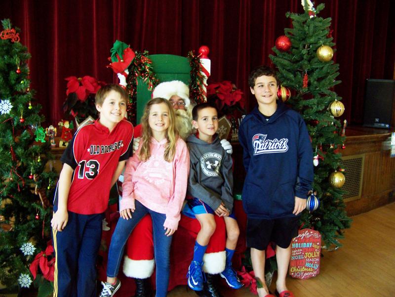 From left, Sam Williamson and Cate, Nick and Samuel Parks of Marion get their picture taken with St. Nick on Saturday. BY MATTHEW BERNAT